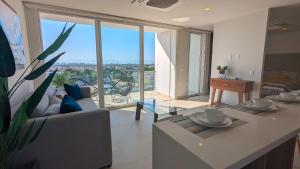 a living room with a couch and a table at Your Perfect Getaway in Vallarta, Pool & Balcony in Nuevo Vallarta