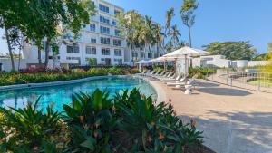 a hotel with a swimming pool in front of a building at Your Perfect Getaway in Vallarta, Pool & Balcony in Nuevo Vallarta