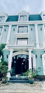 a large blue building with stairs and a balcony at Camly Chic Villa in Da Lat