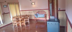 a room with a table and chairs and a stove at Descanso llafenco in Minetué