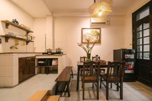 a kitchen with a table and chairs in a room at Oh Trendy Homes Hoan Kiem PNL3 in Hanoi
