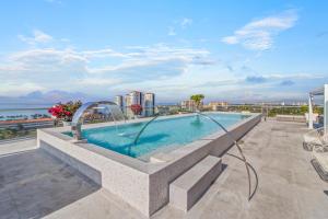 a swimming pool on the roof of a building at Marina Vallarta with View and Pool in Puerto Vallarta