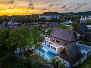 an aerial view of a house with a swimming pool at Bang Tao 6-bedroom large private pool modern Balinese style leisure holiday villa BBQ family group the park in Laguna Phuket