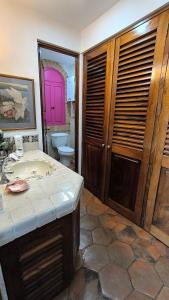 ein Badezimmer mit einem Waschbecken und einem WC mit einer lila Tür in der Unterkunft Studio on the beach and beautiful sea view in Puerto Vallarta + 20 Fotos