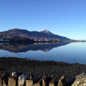 a view of a mountain reflecting in a body of water at Ceol Na Mara in Westport