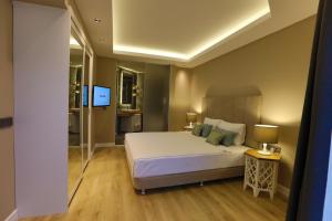 a bedroom with a bed and a flat screen tv at Hotel Vita Bella Resort & Spa in Gundogan +132 photos