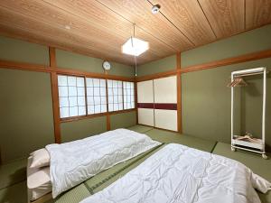 a bedroom with a large bed in a room at Summer Cool Forest Cottage-北軽井沢 夏涼の森コテージ- in Tsumagoi