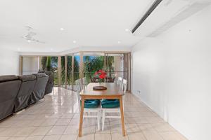 a living room with a table and a couch at The Crabpot in Airlie Beach