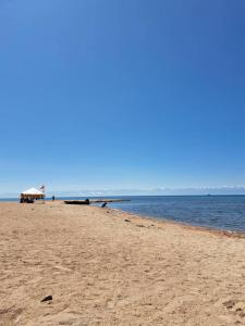 a sandy beach with a view of the ocean at Квартира ЦТ Алматы Иссыкуль in Cholpon-Ata