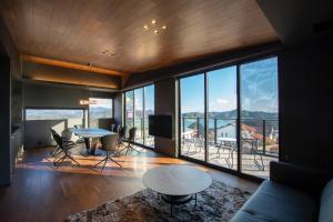 a living room with a table and a large window at Awaji-shima C-Side Hill Top Terrace - Vacation STAY 88185v in Minamiawaji