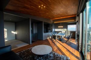 a living room with a table and a dining room at Awaji-shima C-Side Hill Top Terrace - Vacation STAY 88185v in Minamiawaji