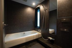 a bathroom with a bath tub and a window at Awaji-shima C-Side Hill Top Terrace - Vacation STAY 88185v in Minamiawaji +15 photos