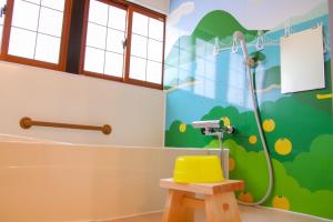 a bathroom with a shower with a yellow toilet at Okamuran Shimanami Goten - Vacation STAY 95664v in Imabari