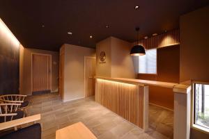 a kitchen with a bar and chairs in a room at Kyoyado Heianshiki - Vacation STAY 00358v in Kyoto