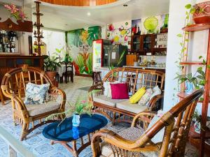 a room with wicker chairs and tables in a store at Sarisa House in Iquitos