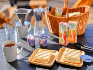 a table with bread and a cup of coffee and baskets of snacks at Mt,Fuji Glamping Terrace Minenohana - Vacation STAY 35720v in Oishi