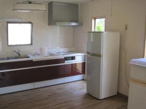 a kitchen with a refrigerator and a sink at Glamp House DAISEN Garden - Vacation STAY 97255v in Yonago +19 photos
