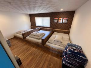 a small bedroom with two beds in a room at SunSet Villa - Vacation STAY 52994v in Nagaoka