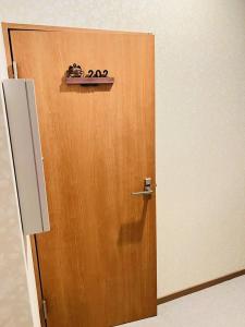 a wooden door with a sign on top of it at Fukuinn - Vacation STAY 35094v in Takamatsu