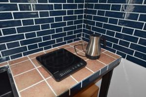 a counter with a blender on a blue tile wall at GRANDPA'S HOUSE Barchanchi - Vacation STAY 53569v in Naha