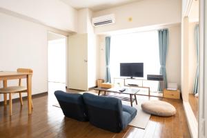a living room with a couch and a table at RIVER WEST Hiroshima 302, 305, 306 - Vacation STAY 54075v in Ōsukachō