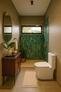 a bathroom with a toilet and a shower with green tiles at KUUL Villas in Baan Tai