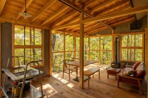 a room with windows and a living room with a table at Nasu Fantasy House - Vacation STAY 13590 in Nasu-yumoto