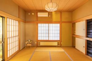 an empty room with yellow walls and windows at Nasu Fantasy House - Vacation STAY 13590 in Nasu-yumoto +18 photos
