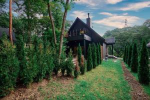 a house with a row of christmas trees in front of it at SAUNA FOREST CABIN Karuizawa Miyota - Vacation STAY 23176v in Oiwake