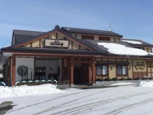 a building with snow on top of it at Art Salon Hosokawa - Vacation STAY 13626 in Sapporo