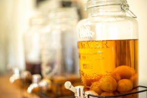 a glass jar of orange juice with oranges in it at Chillps - Vacation STAY 77708v in Iida
