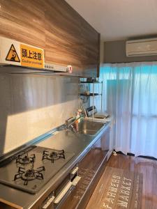 a kitchen with a sink and a stove top oven at Kawaramachi Station · home - Vacation STAY 37891v in Takamatsu