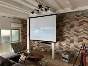 a living room with a large screen on a wall at Onomichi - House - Vacation STAY 13636 in Onomichi