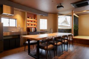 a kitchen with a large wooden table and chairs at Kokin Tengachaya - Vacation STAY 39138v in Osaka