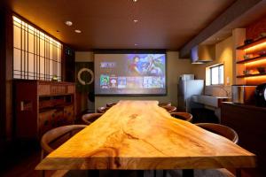 a large wooden table in a kitchen with a large screen at Kokin Tengachaya - Vacation STAY 39138v in Osaka