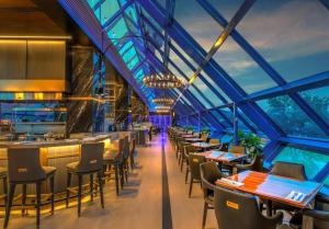 a restaurant with a bar and tables and chairs at Atlantis Casino Resort Spa in Reno