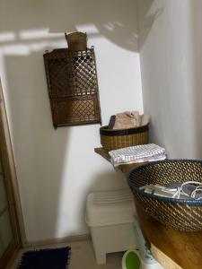 a bathroom with a toilet and baskets on the wall at Chibikko House KK - Vacation STAY 54176v in Oshima