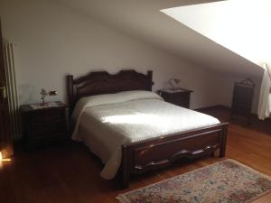 1 dormitorio con 1 cama grande y 2 mesitas de noche en La Spiga, en Rieti