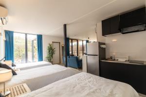 Cette chambre comprend deux lits et un réfrigérateur. dans l'établissement OASE HOSHINO FUSU - Vacation STAY 54740v, à Tōzato 14 autres photos