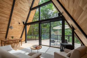 an interior view of a living room with large windows at A-Frame House Minami Karuizawa - Vacation STAY 58046v in Karuizawa +16 photos