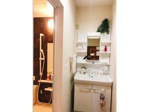 a small bathroom with a sink and a mirror at Guest House SAKURA - Vacation STAY 57751v in Sakura +26 photos