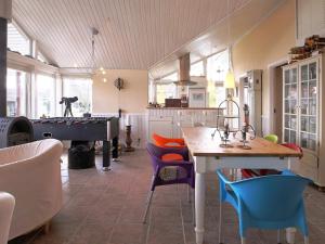 a kitchen with a ping pong table and a pool table at 6 person holiday home in Jægerspris-By Traum in Frederikssund +14 photos