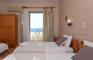 A bed or beds in a room at Vrohaki Studios & Rooms