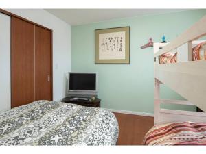 a bedroom with a bed and a television on a table at Art Salon Hosokawa - Vacation STAY 13628 in Sapporo