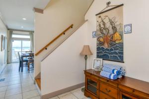 a living room with a staircase and a table at A Pirate's Paradise in St. Augustine