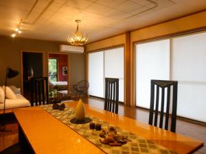 a living room with a table and chairs and a couch at Nonoya - Vacation STAY 78469v in Goto +18 photos