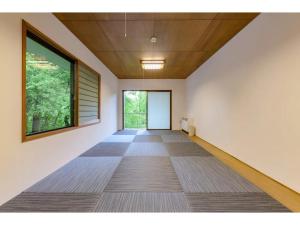 an empty hallway with a large window and white walls at BOOKMARQ yufuin - Vacation STAY 13695 in Yufuin