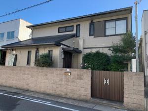 a house with a fence in front of it at Azuma Taku - Vacation STAY 13741 in Kanie