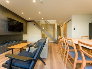 a dining room and kitchen with a table and chairs at Rakuten STAY VILLA Kamogawa Building D with Terrace and sauna Capacity of 10 persons Pets allowed in Kamogawa