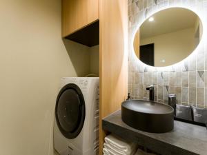 a bathroom with a sink and a mirror at Rakuten STAY VILLA Kamogawa Building B with Terrace and sauna Capacity of 12 persons in Kamogawa +44 photos